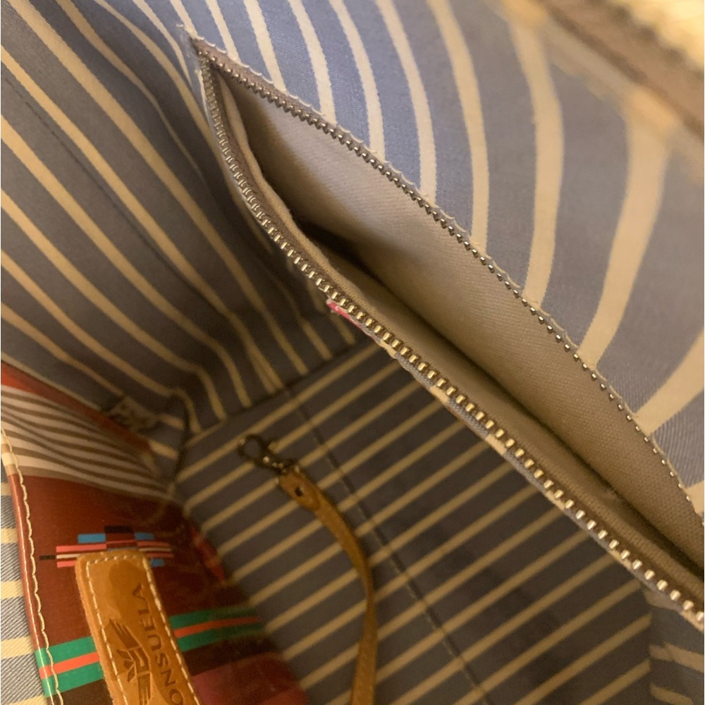 I’m selling a beautiful black with multiple flowers Consuelo original handbag